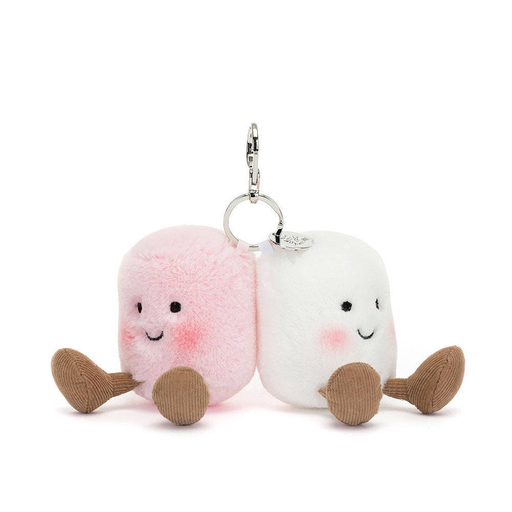 Two plush characters, one pink and one white, with a keychain attached on a white background.