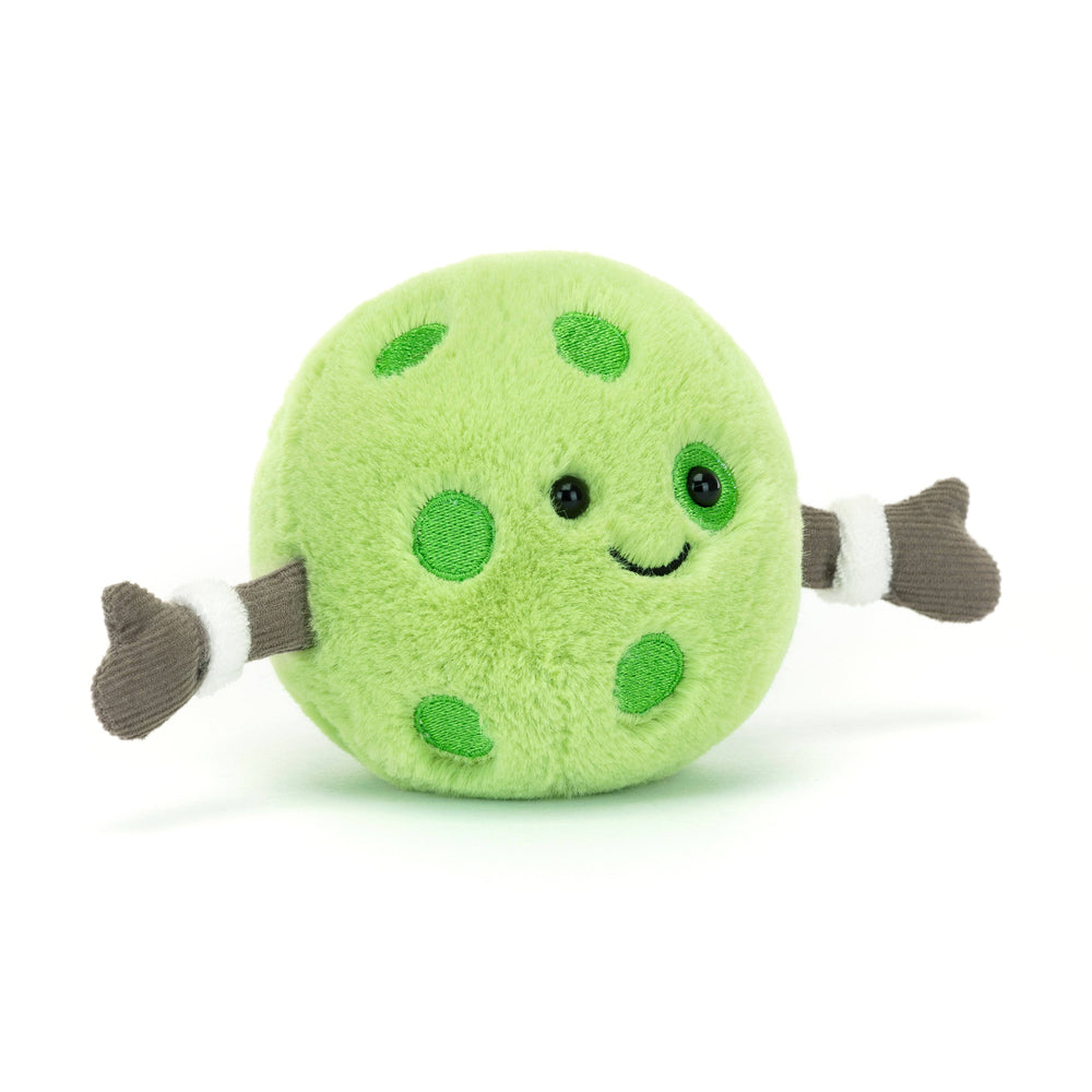 Green plush pickleball  with polka dots and a happy face on a white background