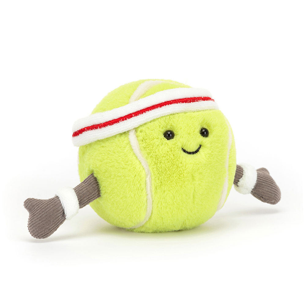 Toy tennis ball with a face, headband, and socks on a white background