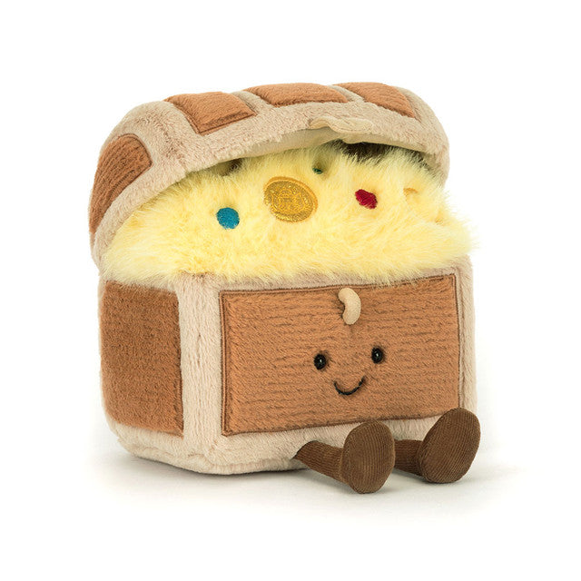 Plush toy resembling a  treasure chest  with a face on a white background