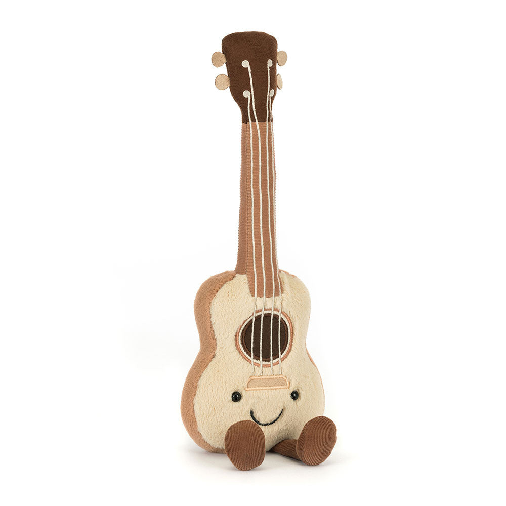 Plush toy guitar with a smiling face on a white background