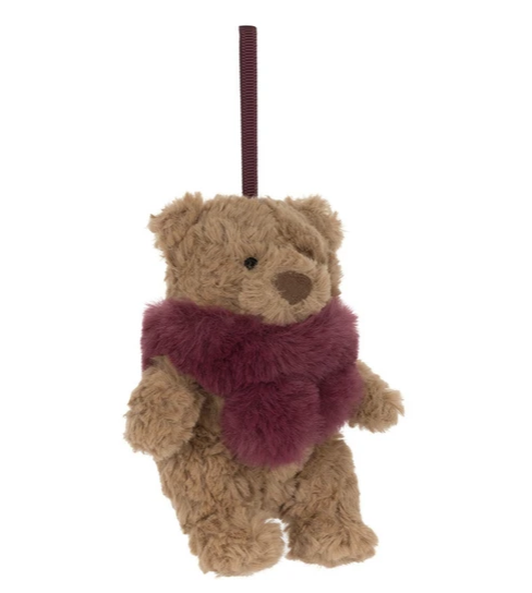 A small plush teddy bear ornament in tan with a fuzzy burgundy scarf and a matching hanging ribbon, shown against a plain white background.