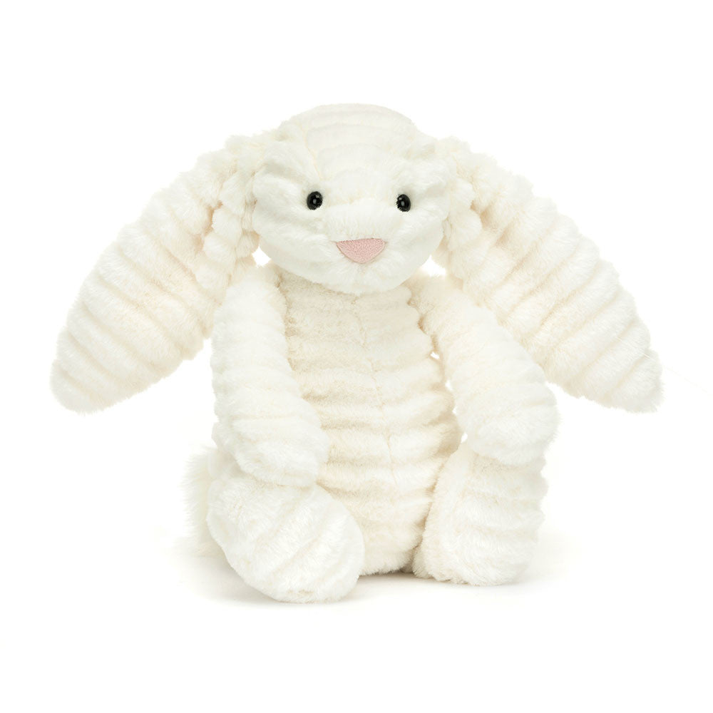A plush toy depicting a Bashful Luxe Bunny Nimbus, with double-cream colored fur, glossy eyes, a silky tail, and a dainty nose.
