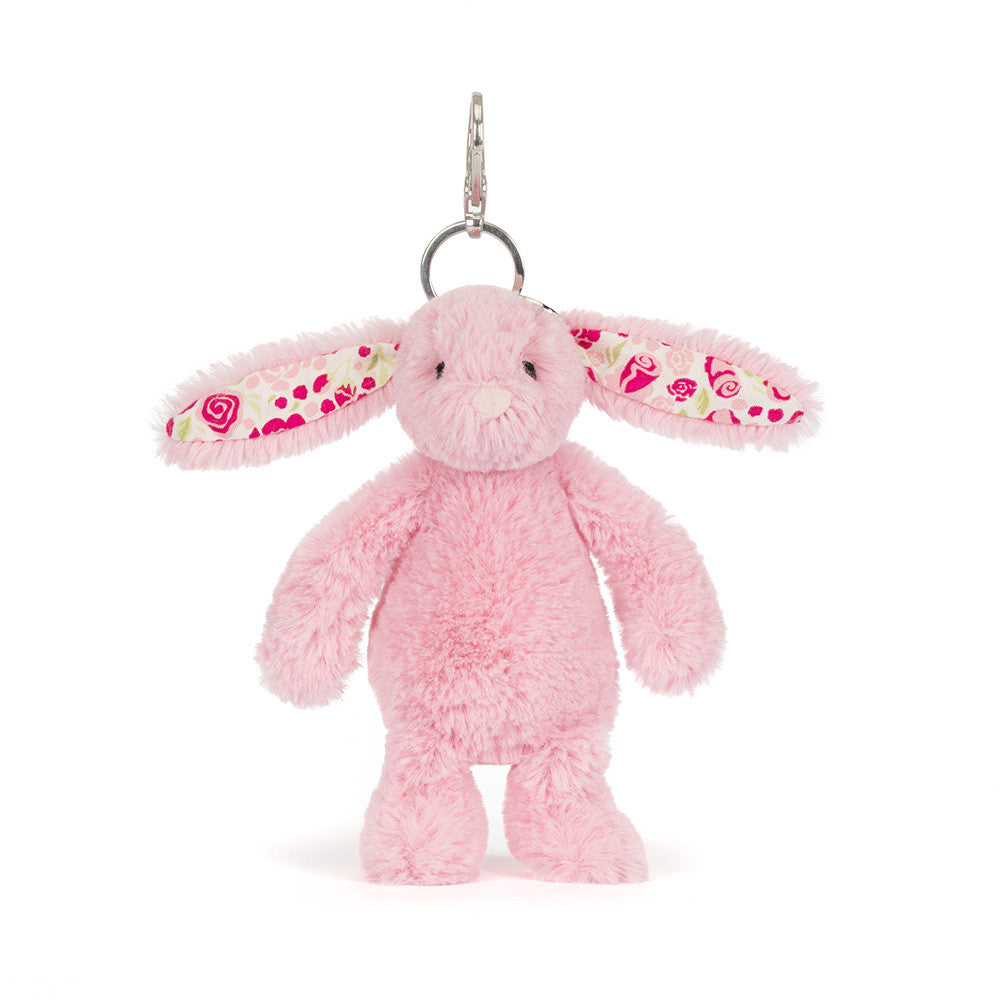 Pink plush bunny keychain with floral ears on a white background