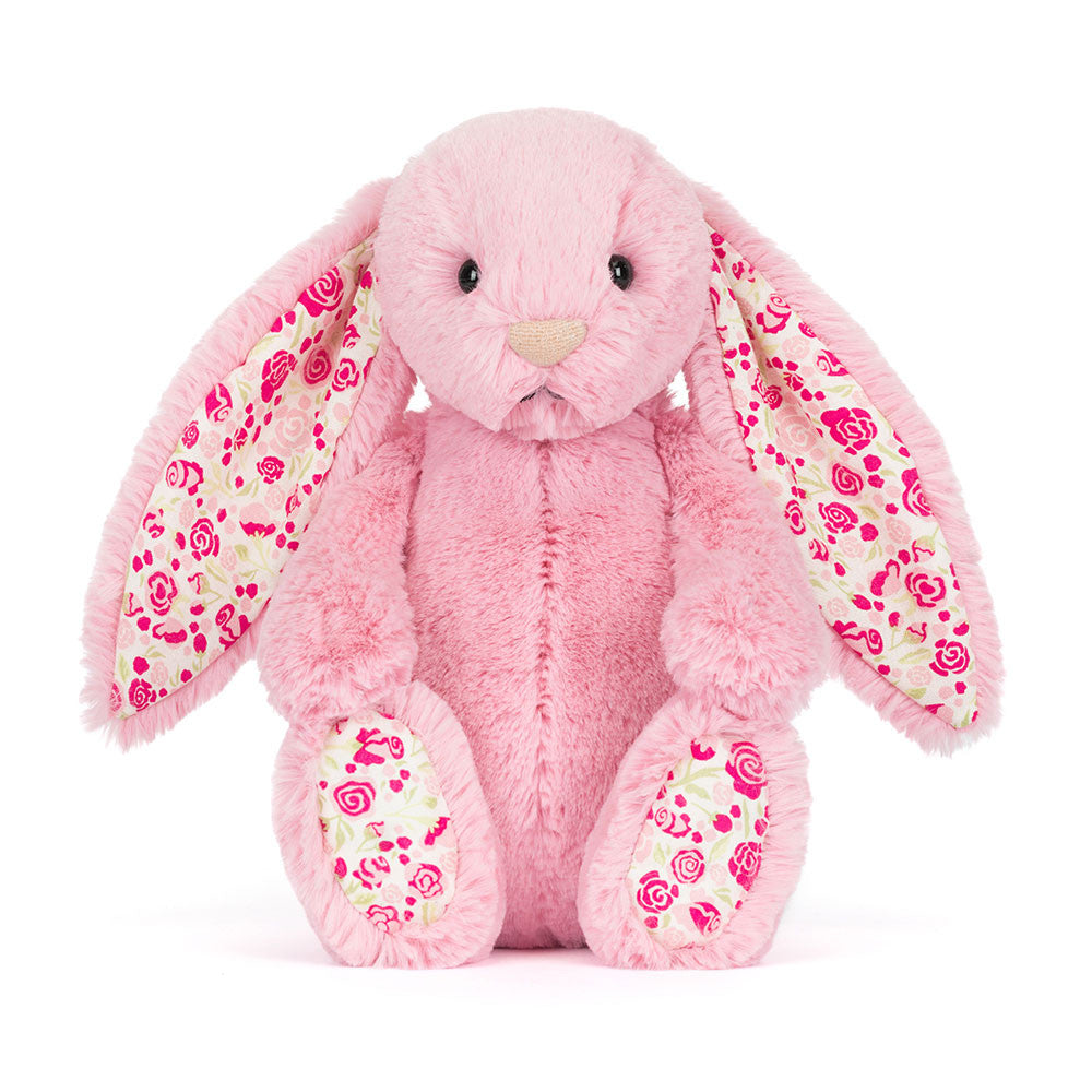 Pink plush bunny with floral patterns on a white background