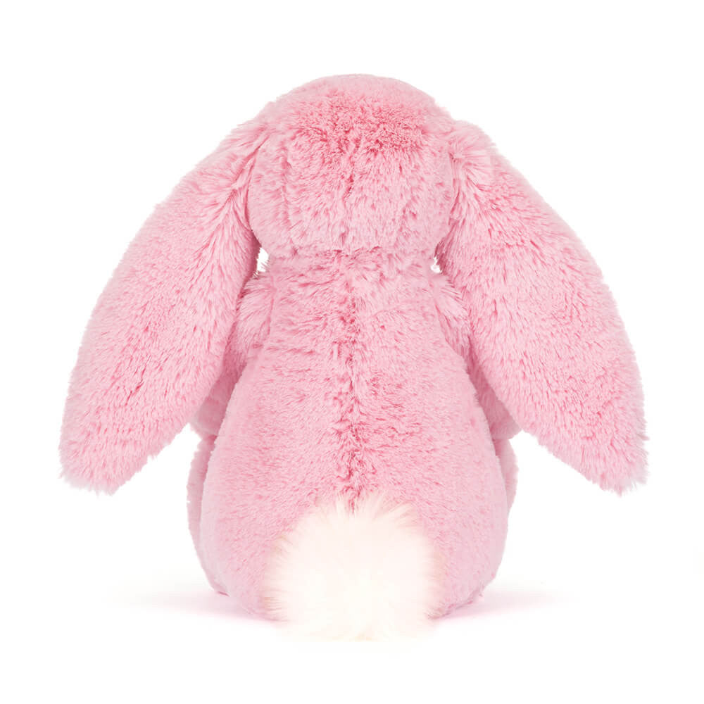 Pink plush bunny toy on a white background