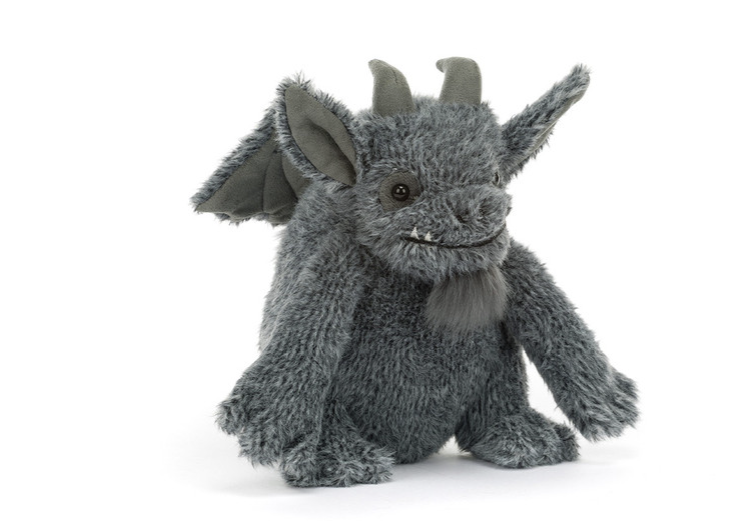 A plush gray dragon toy with textured fur, small horns, wings, and a stitched face, photographed on a clean white background.