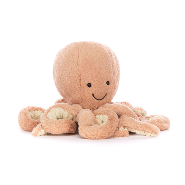 A plush Odell Octopus toy with a smiling face, bright glossy eyes, and eight fine, curly arms in a brick-red color.