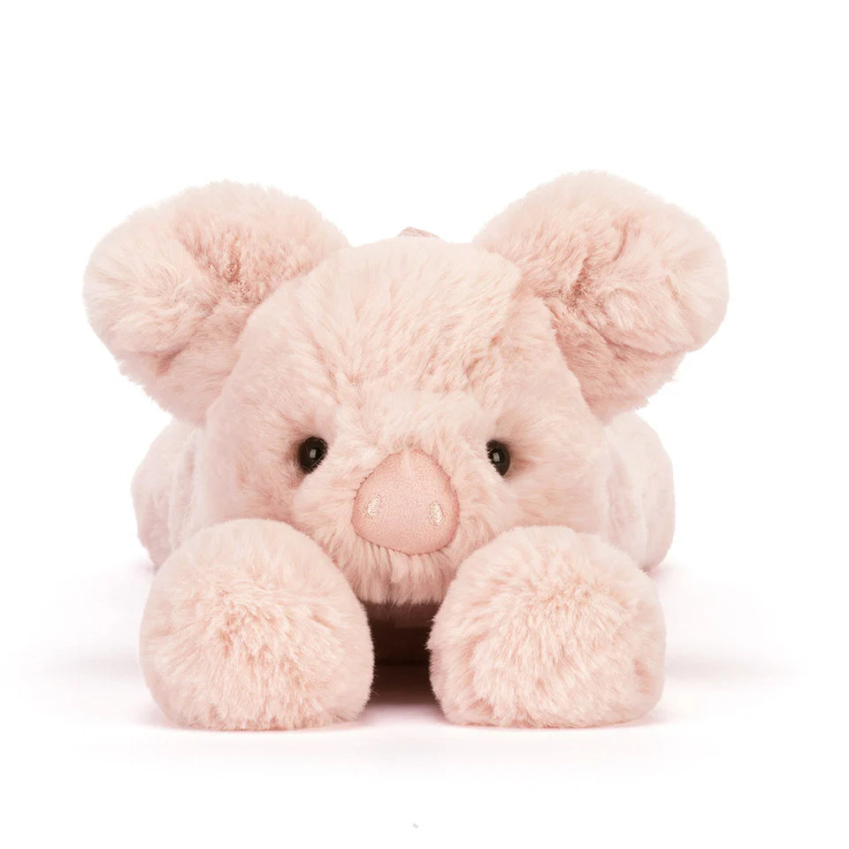 Pink plush pig oy on a white background