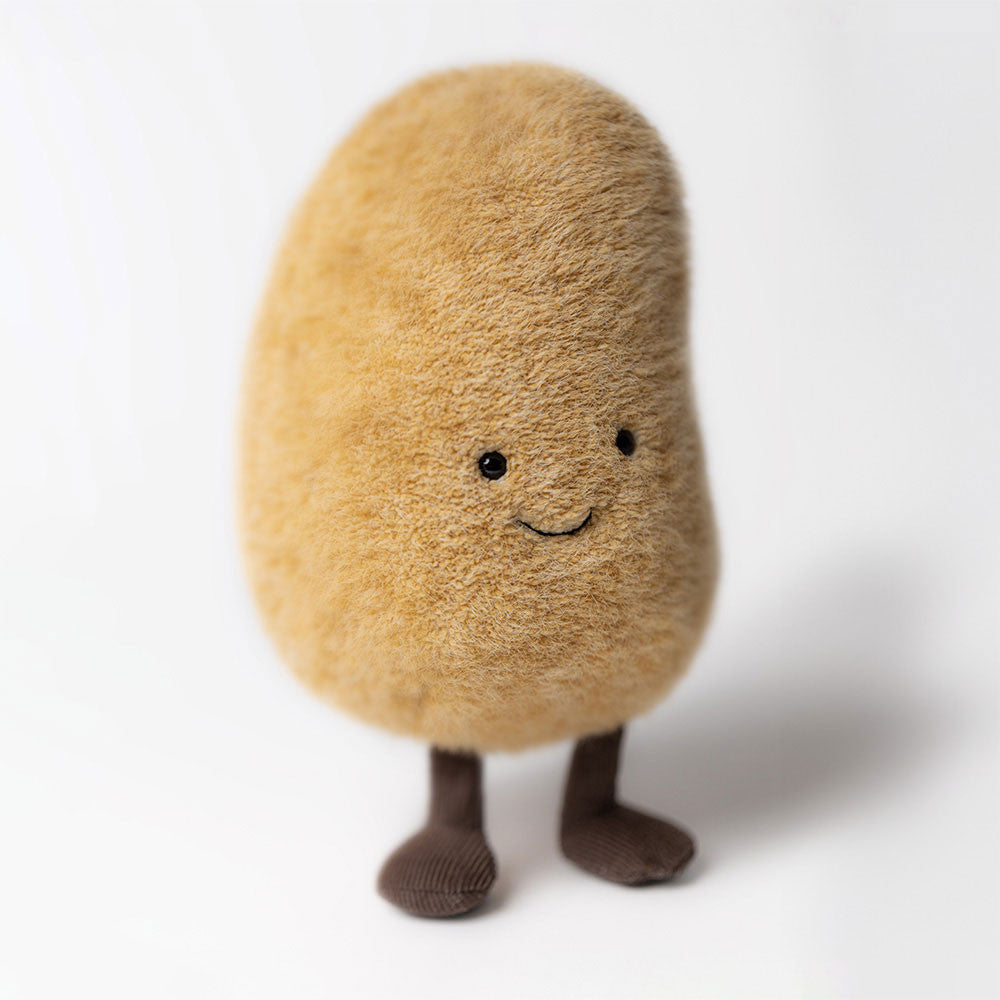 Plush toy 
potato with a smiling face on a white background
