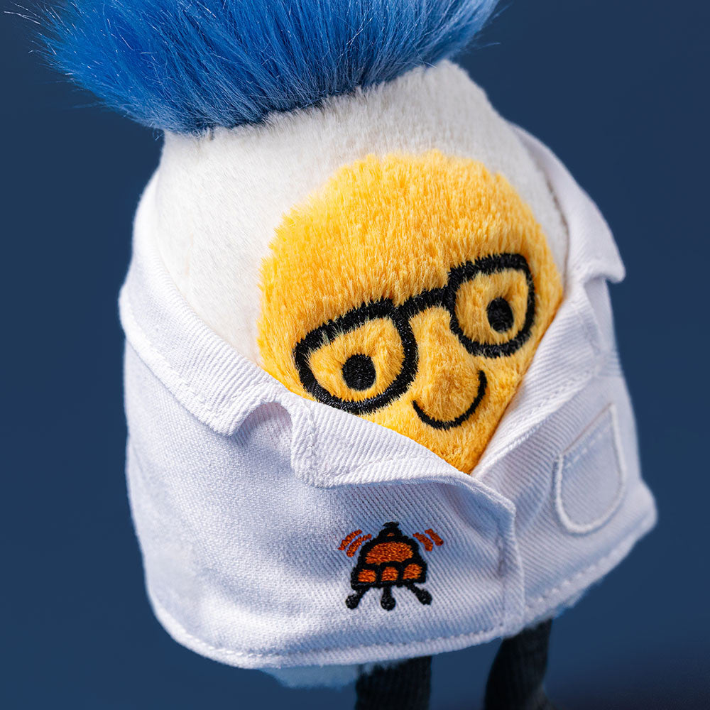 Plush toy with a face design wearing a white shirt on a dark blue background