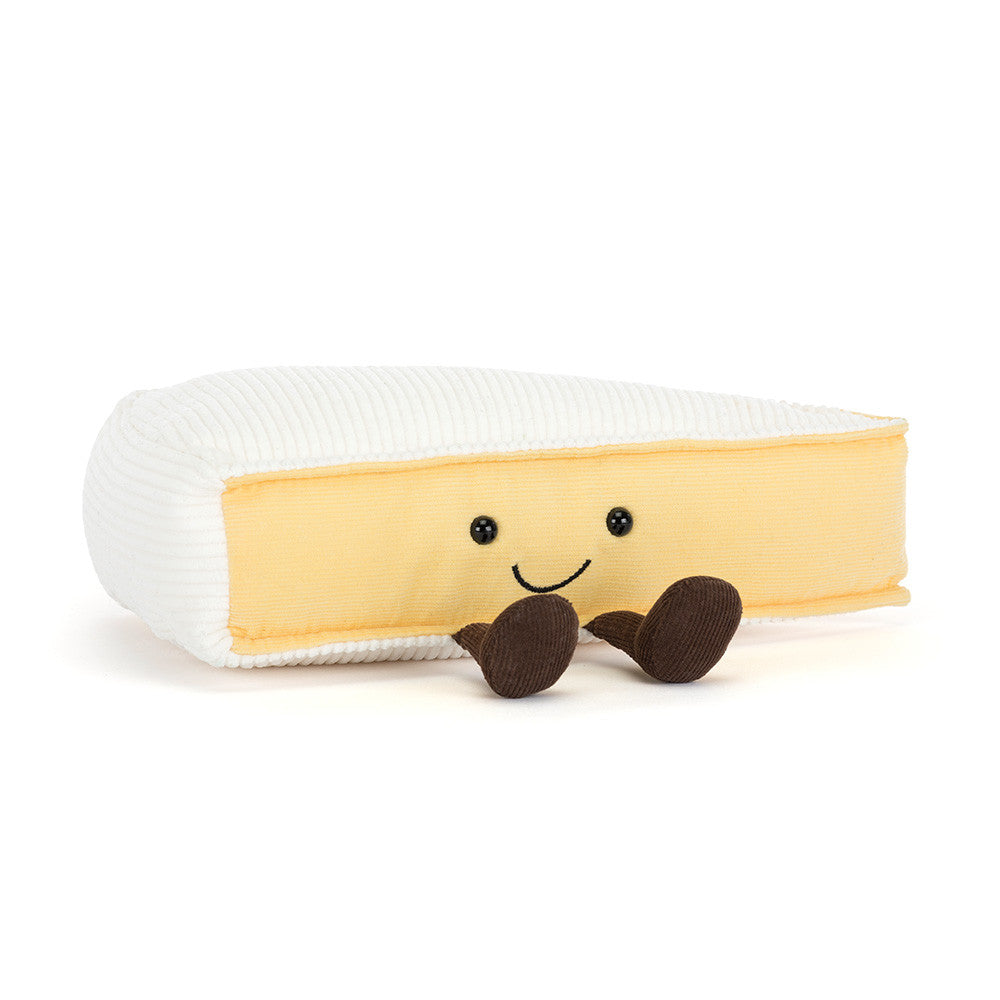 Plush toy brie cheese with a smiling face on a white background