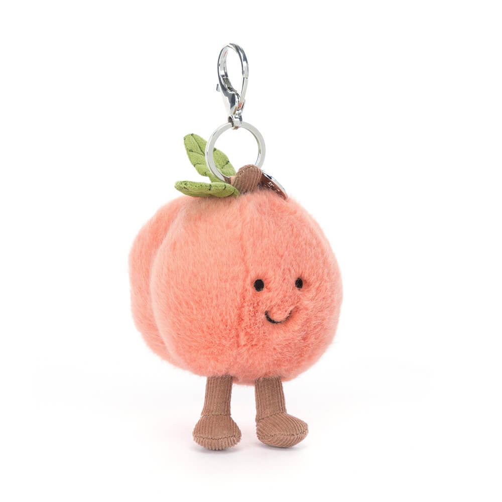 Plush peach character keychain with a white background