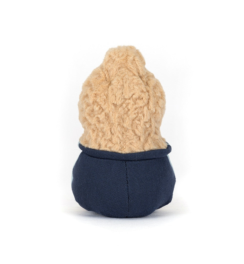 Small plush toy with a beige top and navy bottom on a white background