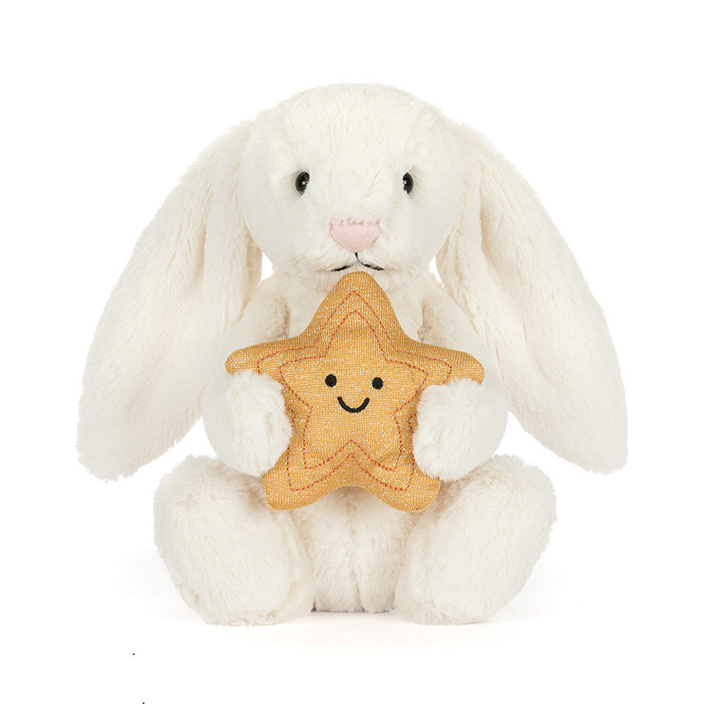 White plush bunny holding a star-shaped cookie with a smiley face on a white background