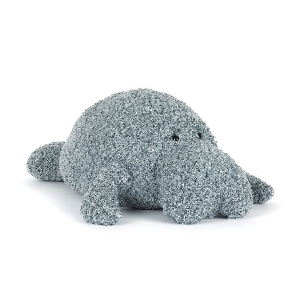 Plush toy hippo with textured surface on a white background