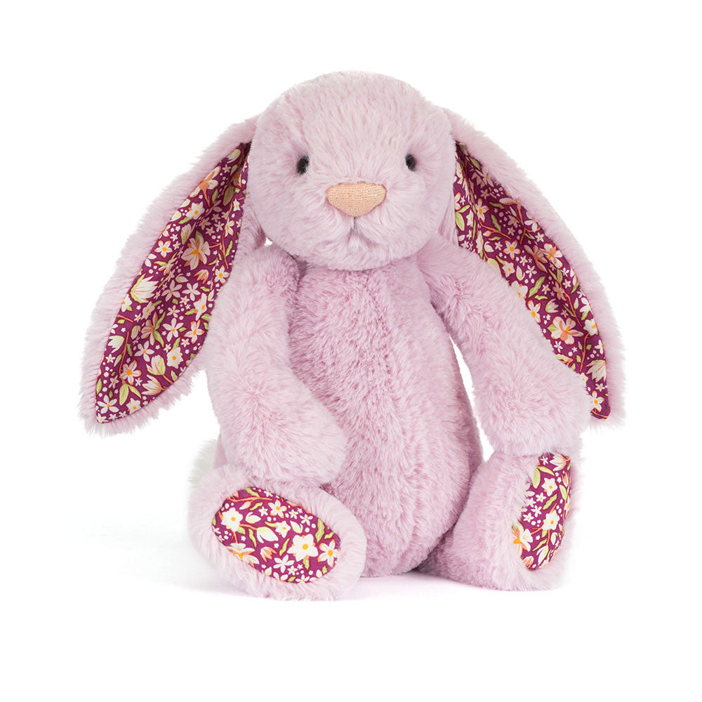 Pink plush bunny with floral ears on a white background