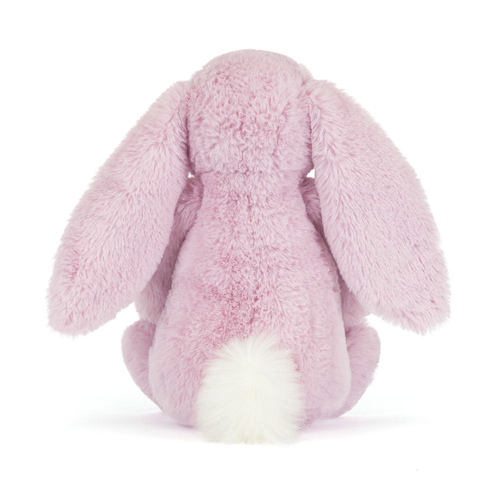 Pink plush bunny toy on a white background