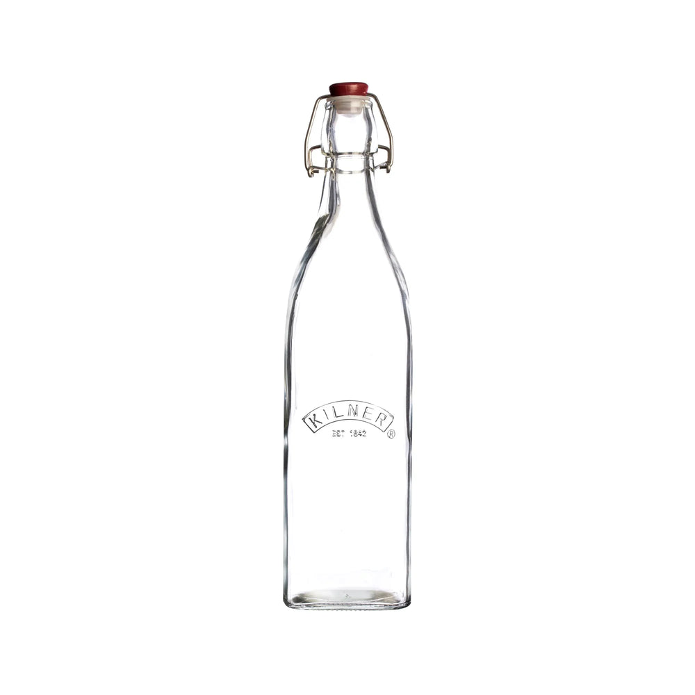 Clear glass bottle with a red cap on a white background, featuring the Kilner brand.