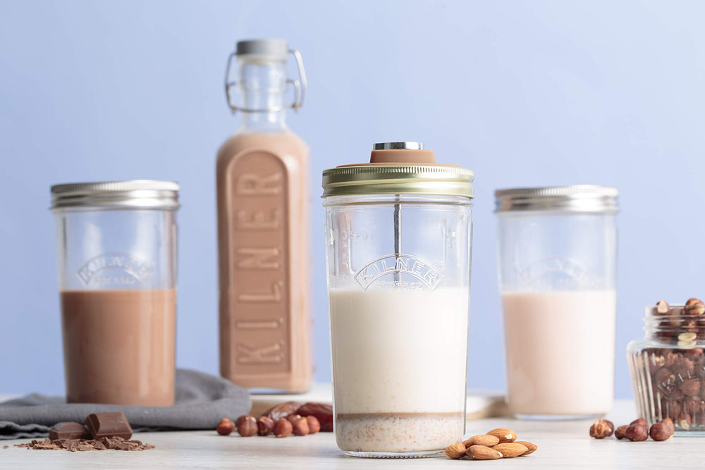 Jars of different sizes with lids on a light blue background