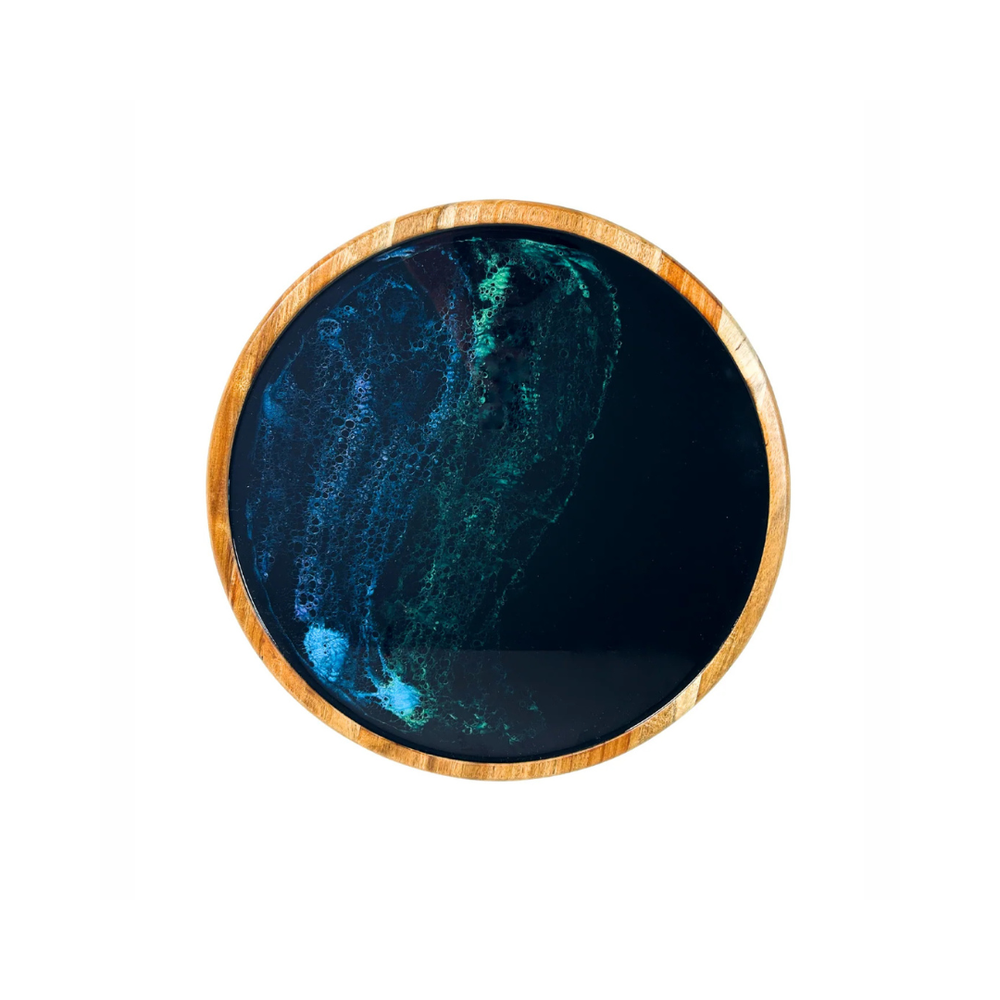 A round Acacia hardwood Lazy Susan with a nothern lights epoxy center and a wood border