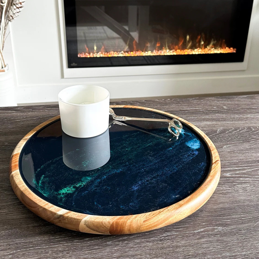 A round Acacia hardwood Lazy Susan with a nothern lights epoxy center and a wood border