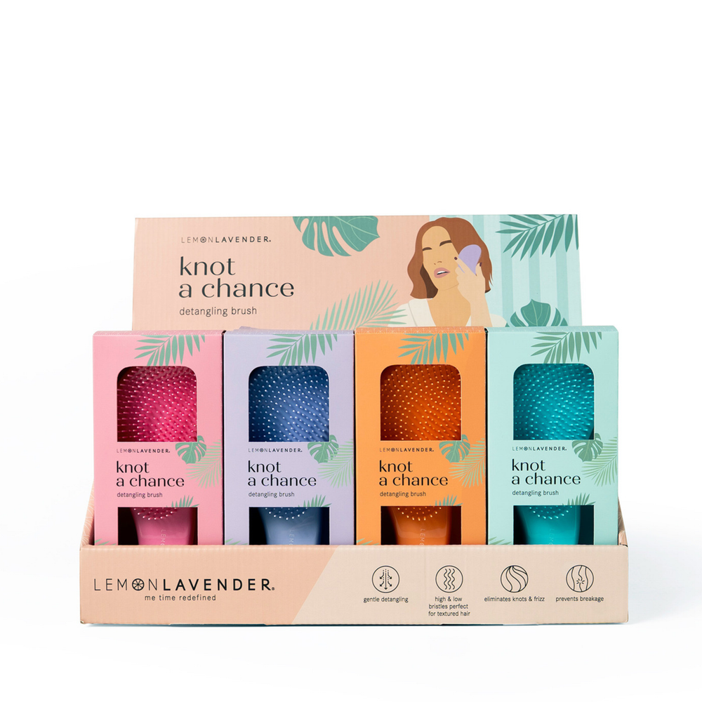 Set of Lemon Lavender hairbrushes in colorful packaging on a white background