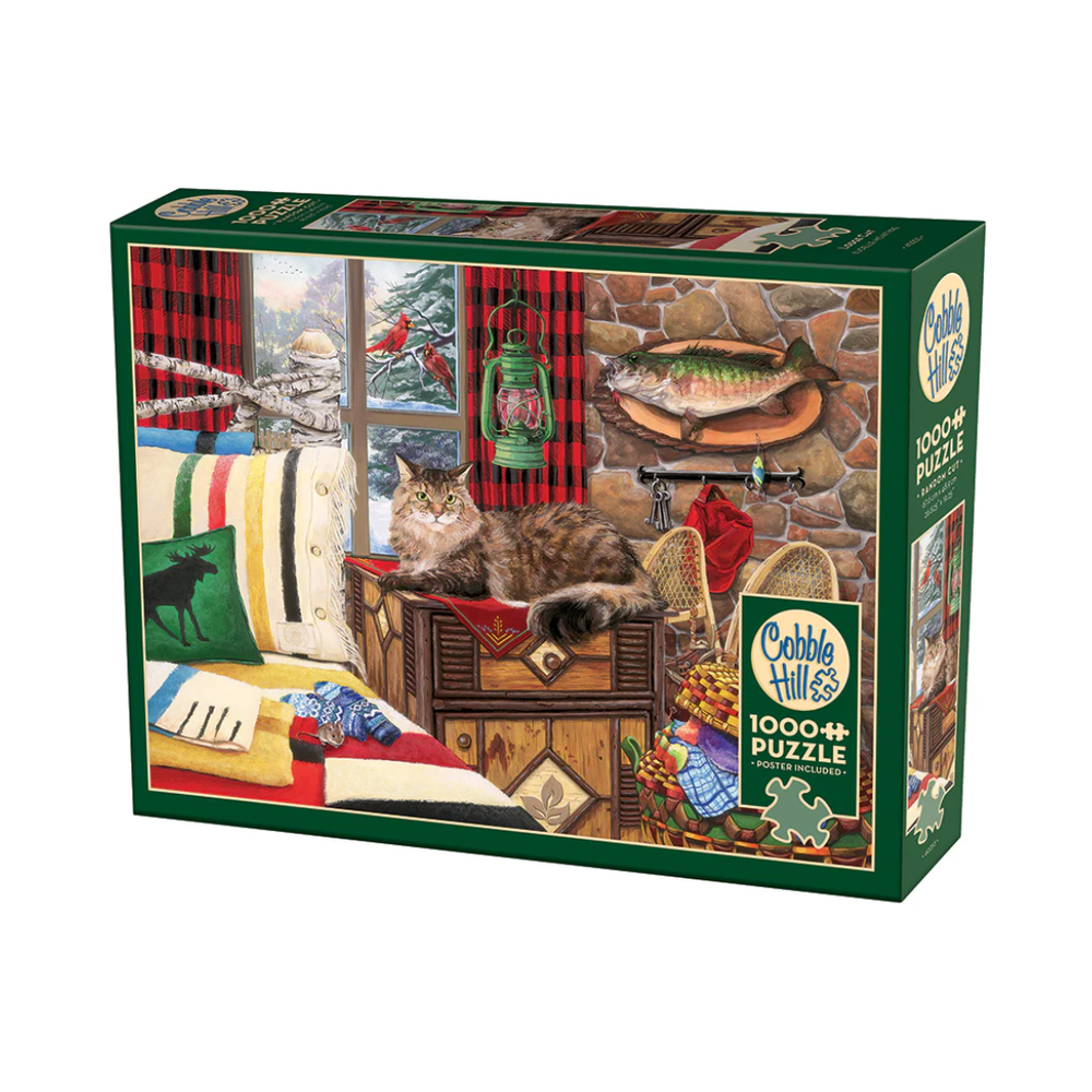 Puzzle box illustration of a cozy cabin scene with a tabby cat on a wooden chest, surrounded by blankets, snow outside the window, and vibrant cardinals.