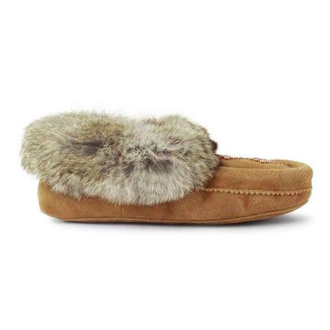 An oak moccasin shoe with a soft, fluffy fur trim around the opening, and intricate stitching along the side.