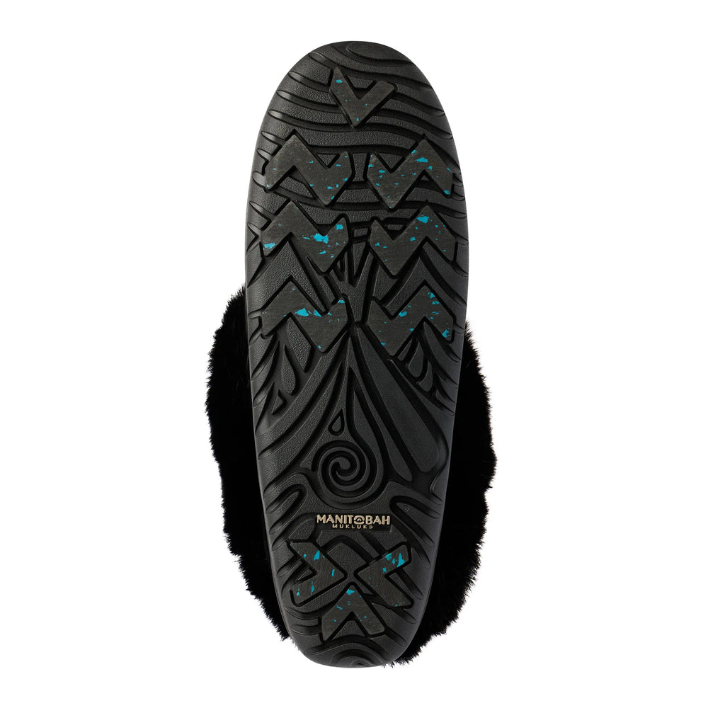 Black boot sole with intricate patterns and turquoise speckles. The brand "MANITOBAH" is visible in the center.