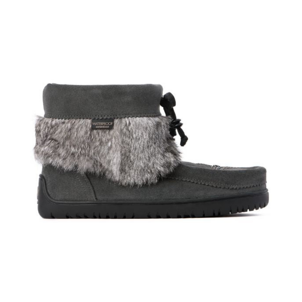 Gray suede ankle boot with faux fur trim and waterproof label. Black rubber sole with ridges; lace-tied bow adds a cozy and stylish touch.
