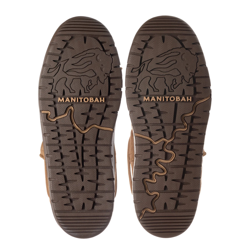 Soles of two brown boots featuring intricate tread patterns. A buffalo design and the word "MANITOBAH".