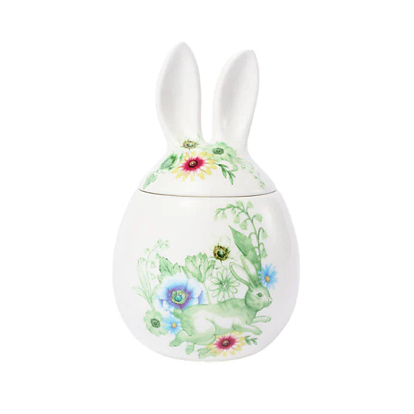 Decorative ceramic egg with bunny ears and floral design on a white background