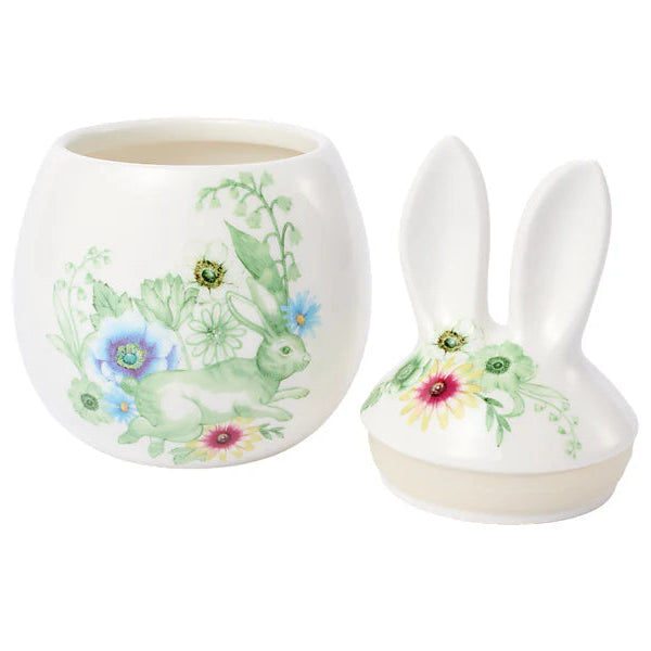 Ceramic container with floral design and bunny ears on a white background