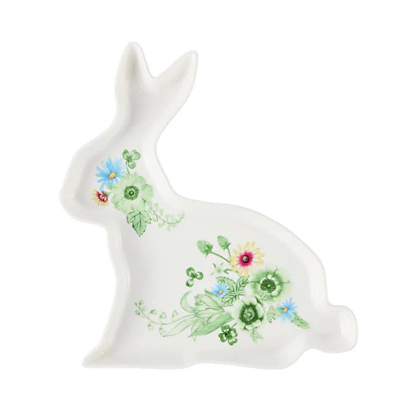 White ceramic rabbit with floral designs on a white background