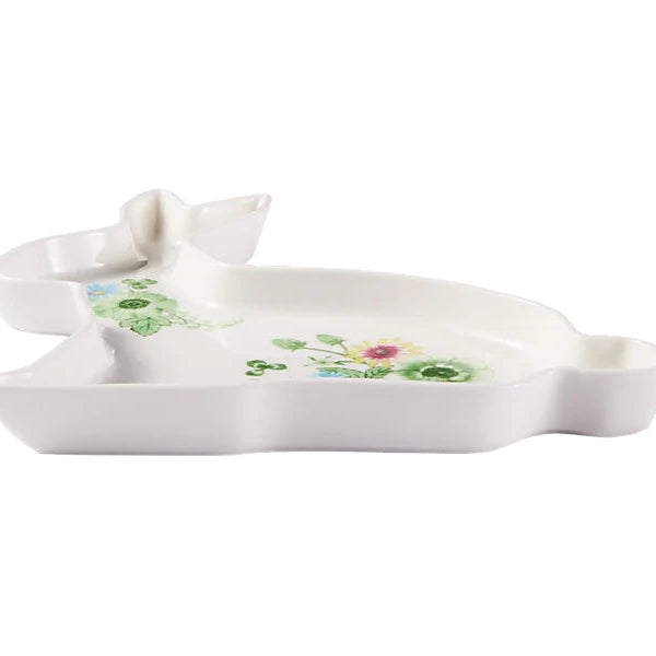 White ceramic dish with floral patterns on a white background