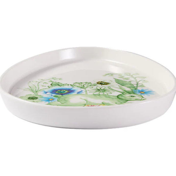 White ceramic dish with floral design on a white background