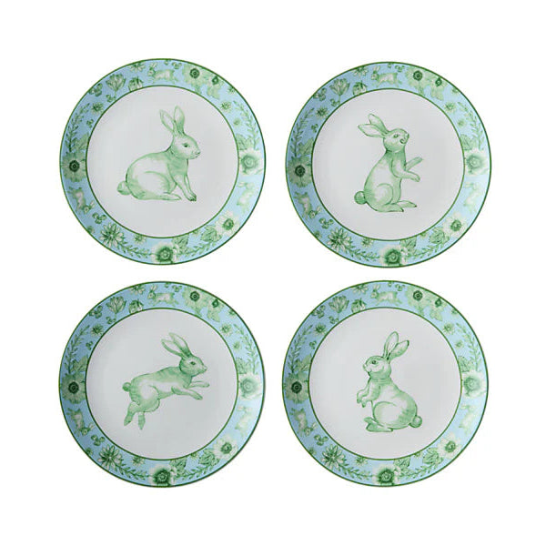 Four decorative plates with green rabbit illustrations on a white background