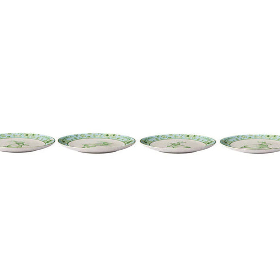 Four ceramic plates with decorative borders on a white background