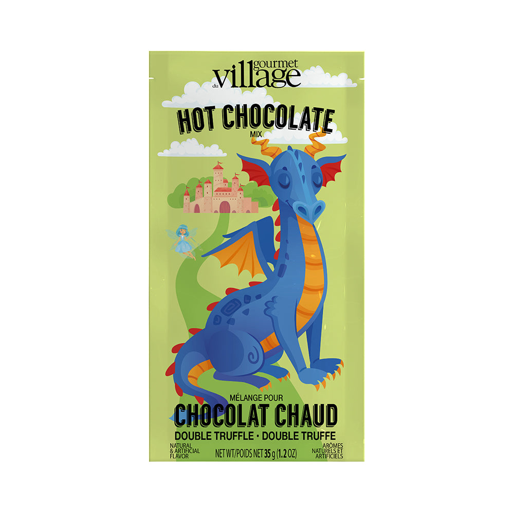 Illustrated green packet of "Gourmet Village Hot Chocolate Mix" with a whimsical blue dragon. Background features a castle and a fairy, giving a magical, playful vibe.