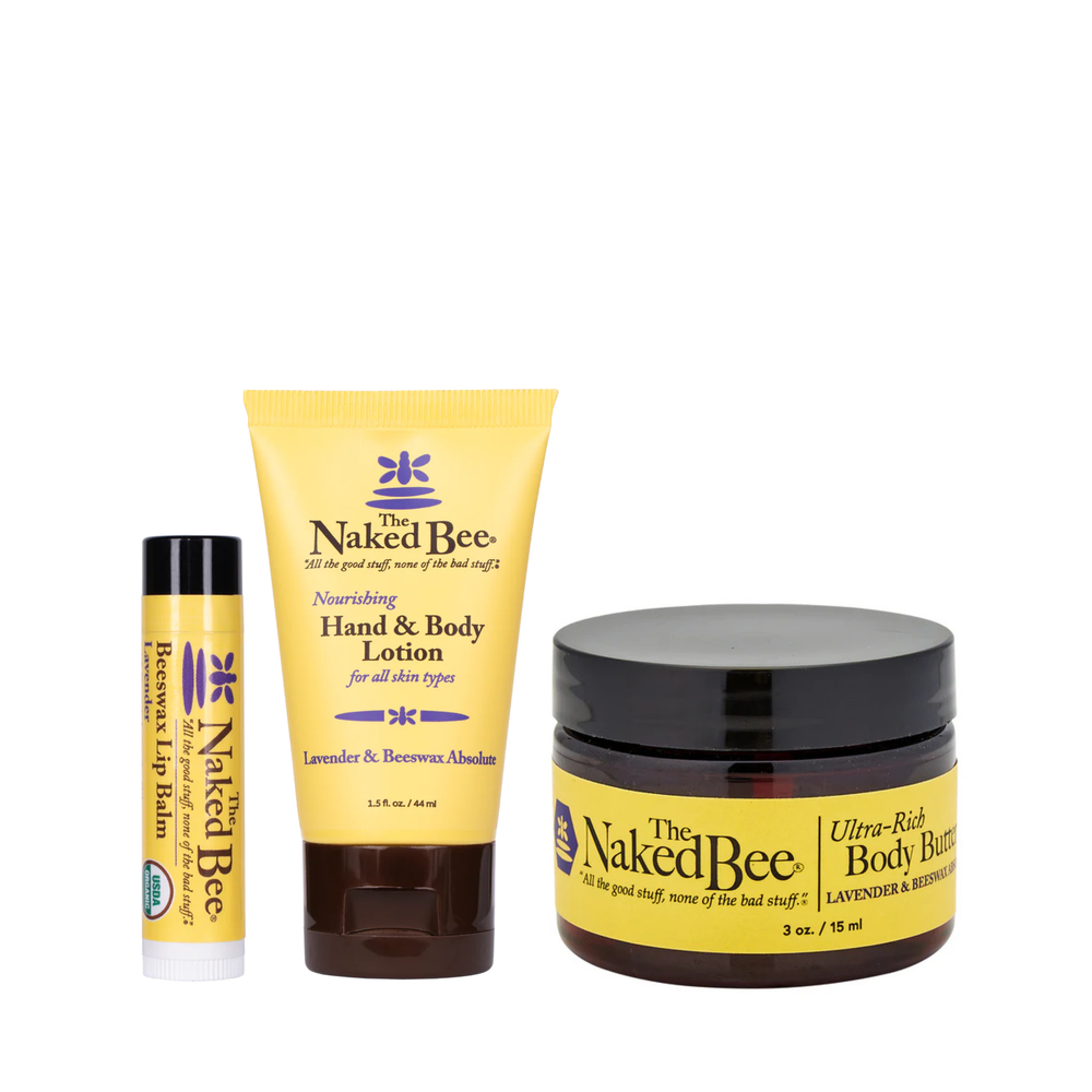 Three Naked Bee products including a lip balm, lotion, and body butter on a white background.