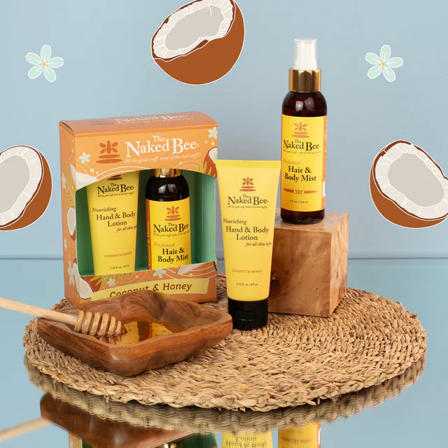 Naked Bee skincare products including lotion, mist, and box on a textured surface with coconut elements.