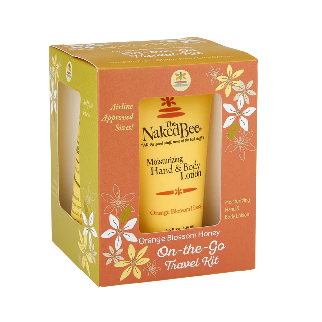 Packaging of The Naked Bee products including hand and body lotion, body wash, shampoo, and conditioner in orange blossom honey scent, presented in a gift set box with 'airline approved' text.