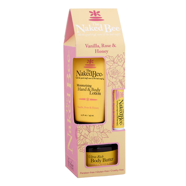 A product image featuring a Vanilla, Rose & Honey gift set by The Naked Bee, containing a bottle of hand & body lotion and a jar of body butter, packaged in a pink box with floral patterns.