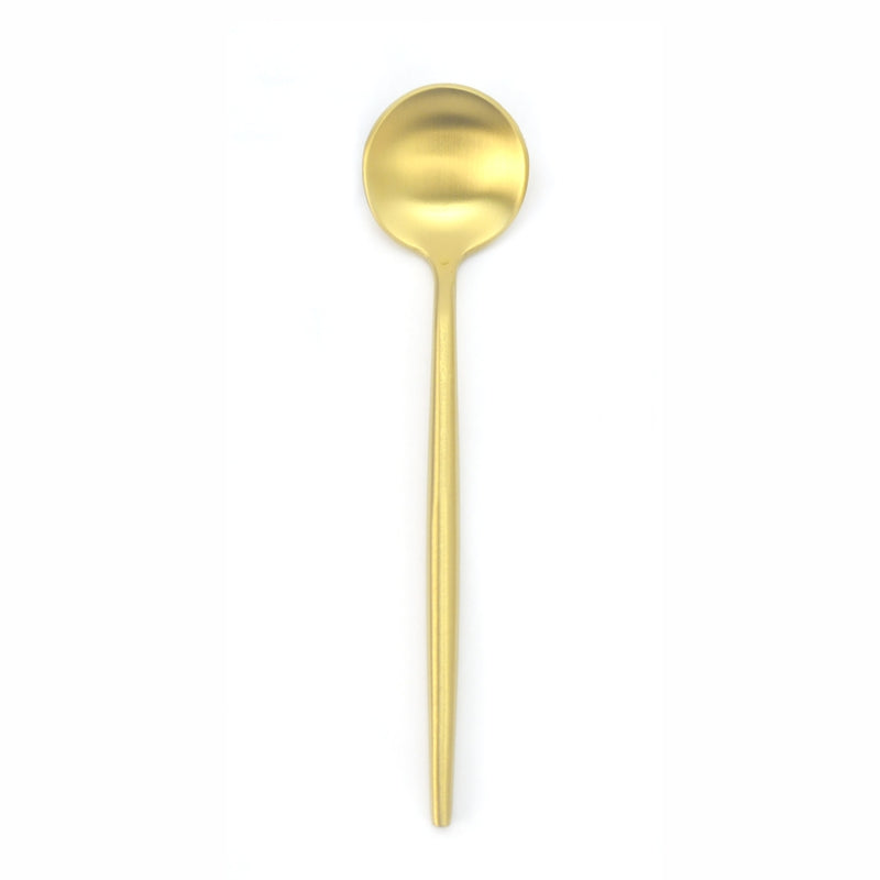 Gold-colored spoon on a white background