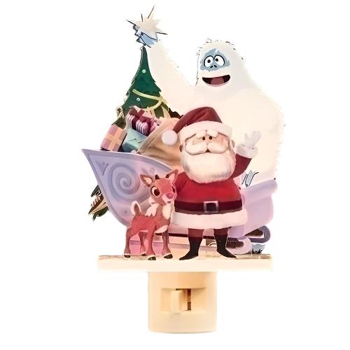 A 3-D plastic nightlight featuring Santa Claus, Rudolph the Red-Nosed Reindeer, and Bumble from Rudolph the Movie, standing in front of a Christmas tree.