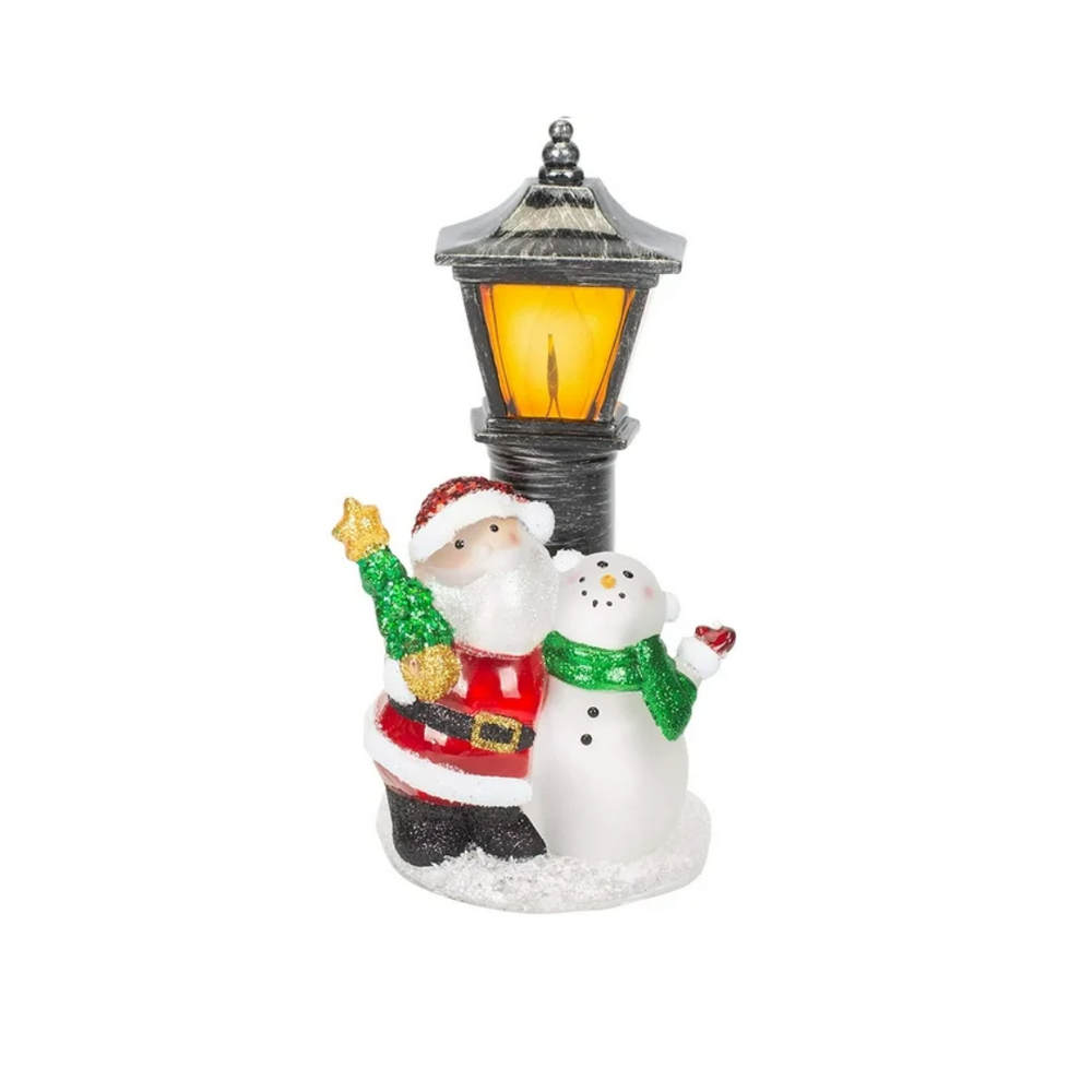 A holiday-themed night light featuring Santa Claus and a snowman standing next to a lamppost with a glowing light bulb.