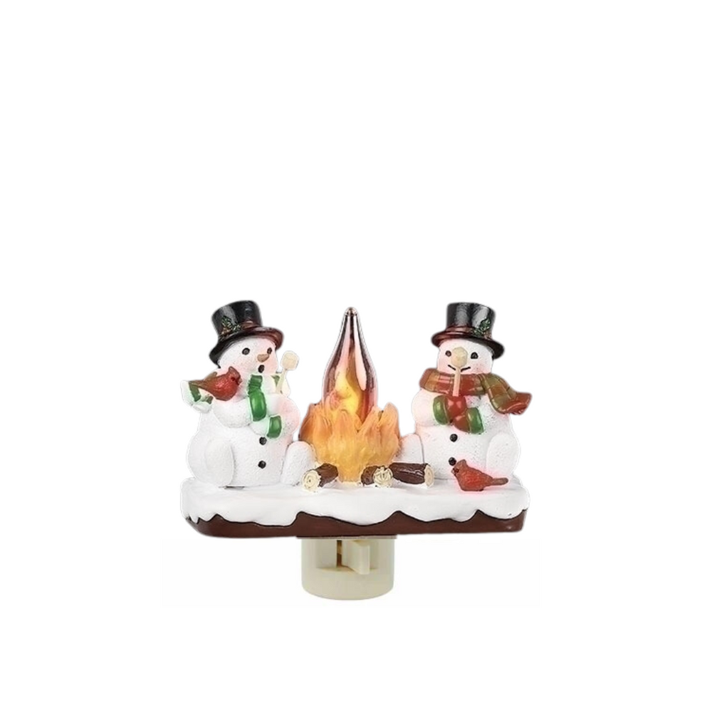 A decorative night light featuring two snowmen sitting around a campfire.