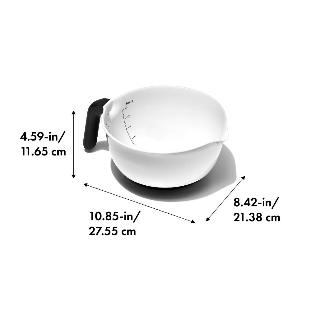White measuring cup with black handle and measurements labeled on a white background
