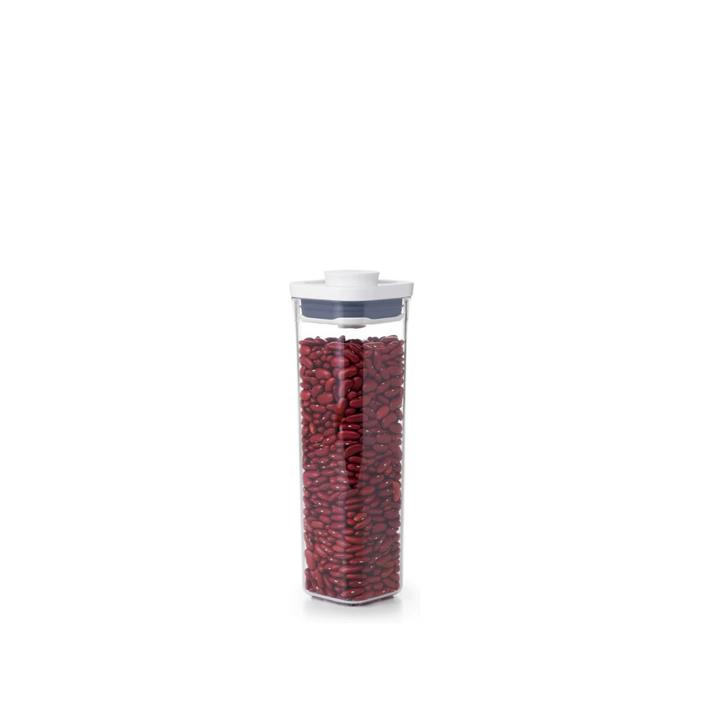 Clear container filled with red beans on a white background